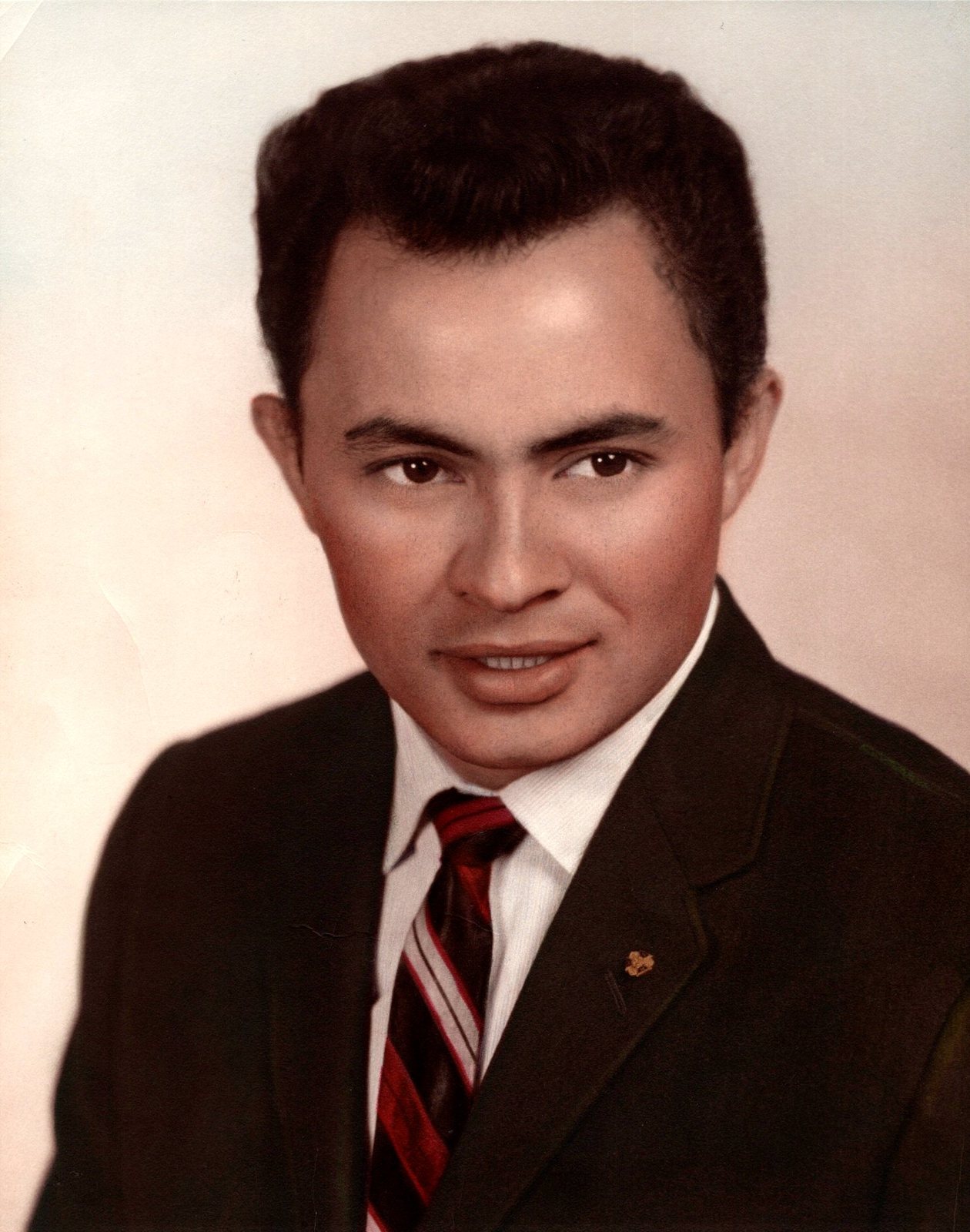 Portrait of Foalima Hokum in 1969, wearing a dark suit and red striped tie.